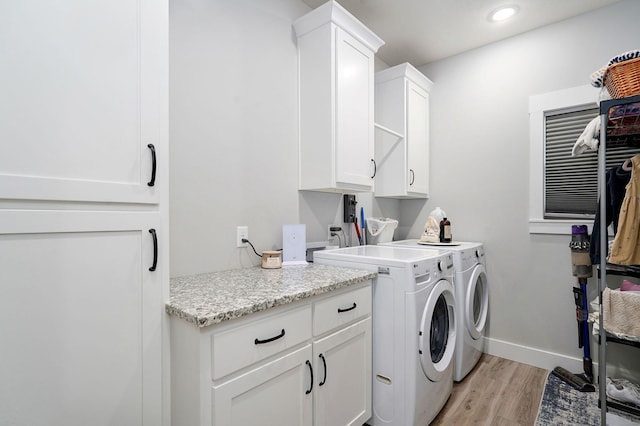 1240 E Keeling Pl, Bolivar, MO 65613 - laundry room with cabinet space, washer and dryer, light wood-style flooring, and recessed lighting