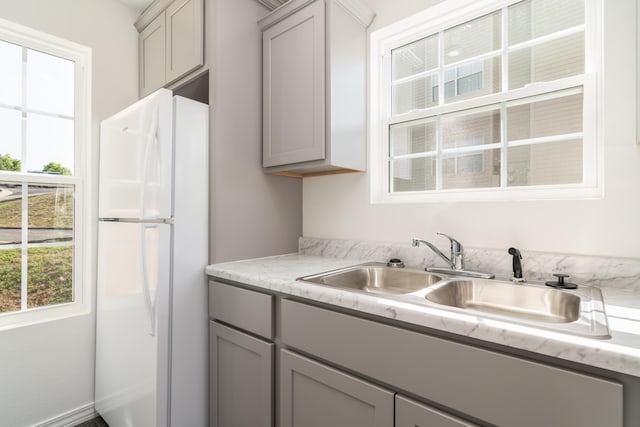 37 Lantern Bay Ln Unit 3, Branson, MO 65616 - kitchen featuring freestanding refrigerator, gray cabinetry, healthy amount of natural light, and light countertops