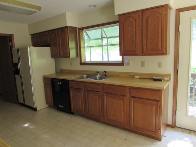 285 Scenic Dr, Forsyth, MO 65653 - kitchen featuring dishwasher, white refrigerator with ice dispenser, light countertops, and brown cabinets