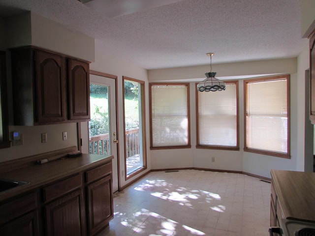 285 Scenic Dr, Forsyth, MO 65653 - unfurnished dining area featuring a textured ceiling and a chandelier