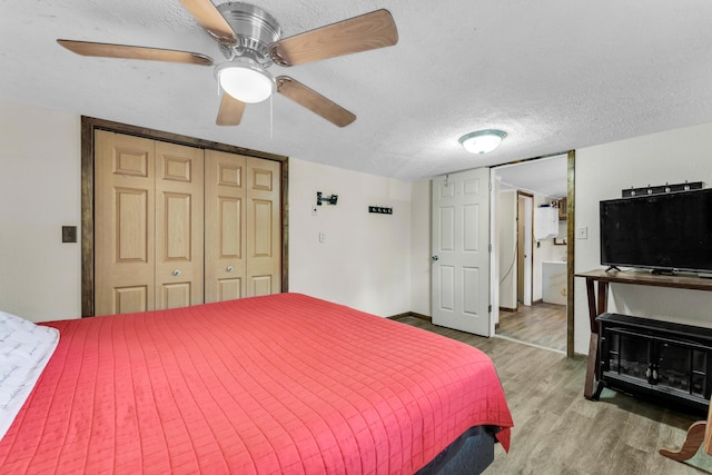 3637 State Highway Y, Forsyth, MO 65653 - bedroom with wood finished floors, a closet, a textured ceiling, and ceiling fan