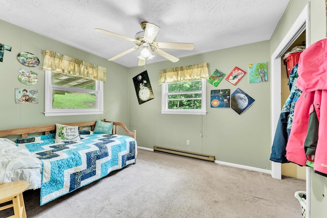 3637 State Highway Y, Forsyth, MO 65653 - bedroom featuring baseboard heating, carpet floors, a textured ceiling, and ceiling fan