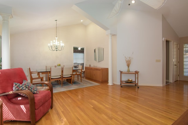 618 Parnell Cir, Branson, MO 65616 - living area with ornate columns, light wood-style floors, a chandelier, high vaulted ceiling, and recessed lighting