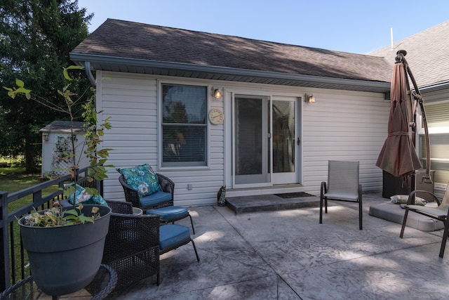618 Parnell Cir, Branson, MO 65616 - back of property featuring a shingled roof and a patio area