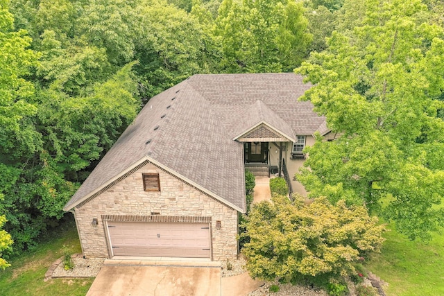 277 Country Bluff Dr, Branson, MO 65616 - view of front of home with stone siding, roof with shingles, concrete driveway, and a garage