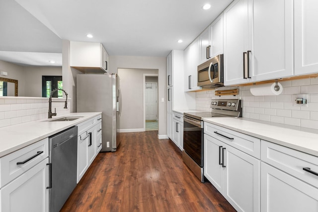 277 Country Bluff Dr, Branson, MO 65616 - kitchen with stainless steel appliances, backsplash, white cabinetry, recessed lighting, and dark wood-style flooring