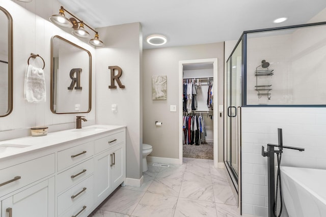 277 Country Bluff Dr, Branson, MO 65616 - bathroom featuring marble finish floors, a shower stall, double vanity, a freestanding bath, and a spacious closet