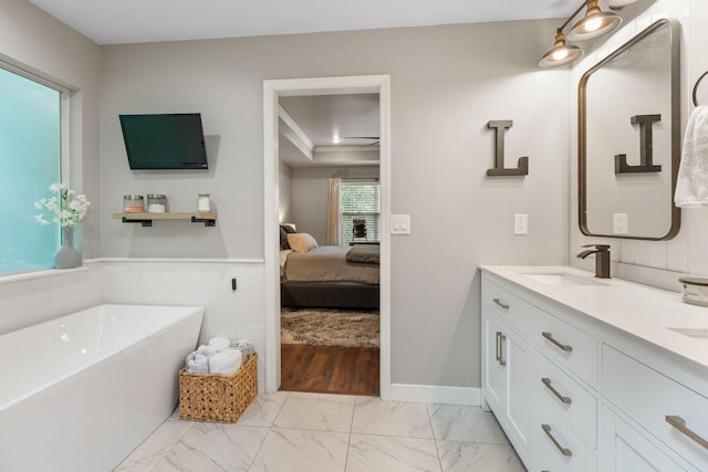277 Country Bluff Dr, Branson, MO 65616 - ensuite bathroom with a freestanding tub, double vanity, and marble look tiles