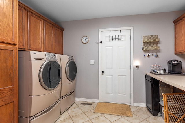 277 Country Bluff Dr, Branson, MO 65616 - laundry area featuring cabinet space, washer and clothes dryer, and light tile patterned floors