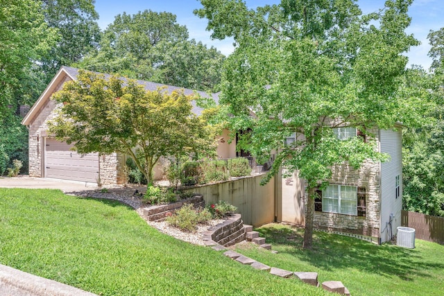 277 Country Bluff Dr, Branson, MO 65616 - view of property hidden behind natural elements with stone siding, driveway, and an attached garage