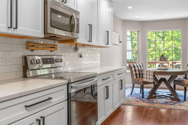 277 Country Bluff Dr, Branson, MO 65616 - kitchen with stainless steel appliances, dark wood finished floors, white cabinetry, and recessed lighting