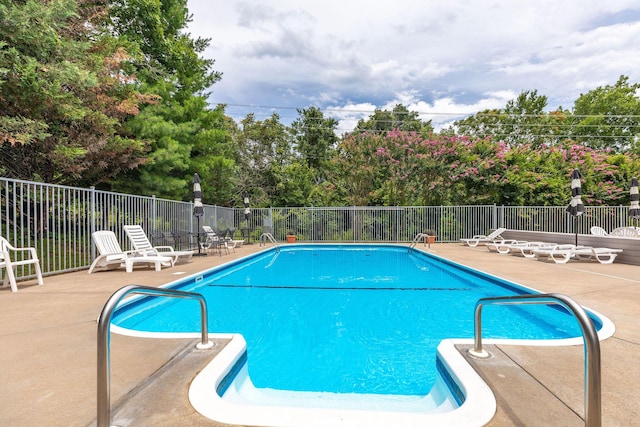 277 Country Bluff Dr, Branson, MO 65616 - community pool featuring a patio area and view of wooded area
