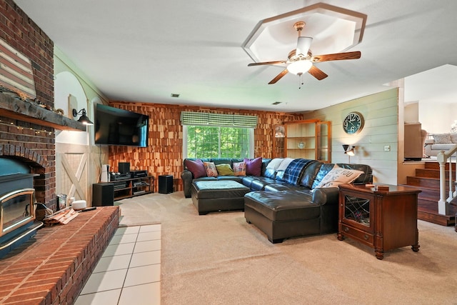 107 Oakwood Dr, Branson, MO 65616 - carpeted living room featuring ceiling fan, wood walls, a wood stove, and stairway