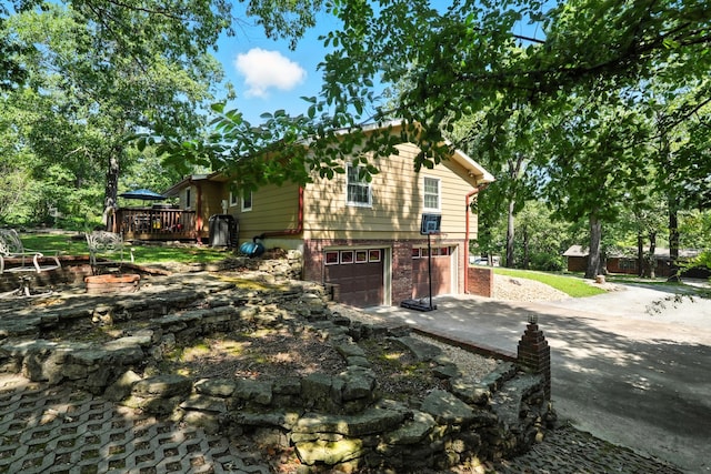 107 Oakwood Dr, Branson, MO 65616 - view of side of property with driveway, an attached garage, and a deck