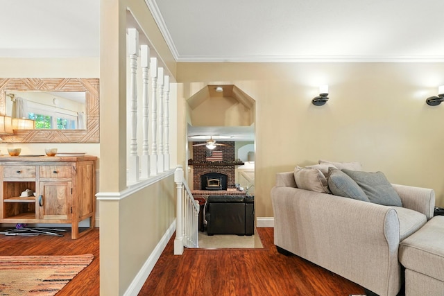 107 Oakwood Dr, Branson, MO 65616 - living room featuring dark wood-type flooring, ornamental molding, a brick fireplace, and ceiling fan