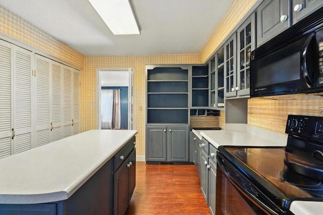 107 Oakwood Dr, Branson, MO 65616 - kitchen with black appliances, dark wood-style floors, light countertops, glass insert cabinets, and gray cabinetry
