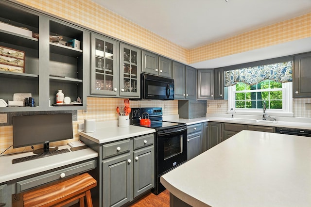 107 Oakwood Dr, Branson, MO 65616 - kitchen featuring black appliances, gray cabinets, backsplash, light countertops, and glass insert cabinets
