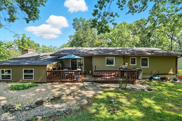 107 Oakwood Dr, Branson, MO 65616 - back of property with a wooden deck, a chimney, and a lawn