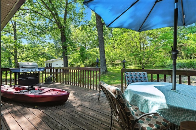 107 Oakwood Dr, Branson, MO 65616 - deck featuring area for grilling, outdoor dining area, and view of wooded area
