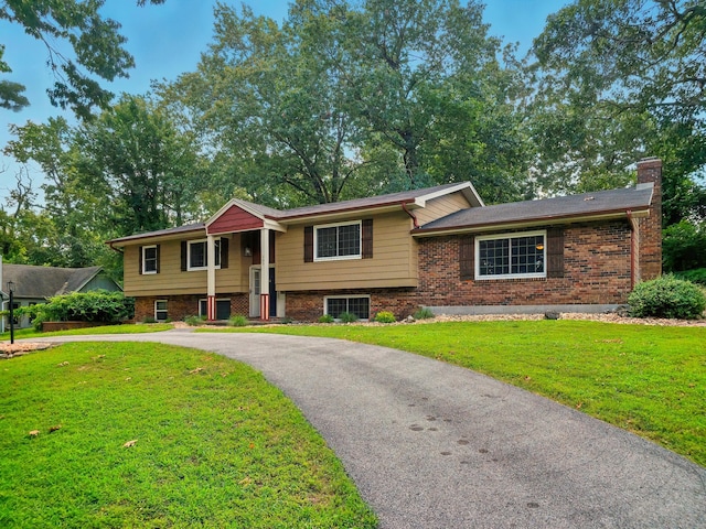 107 Oakwood Dr, Branson, MO 65616 - view of front of house with a chimney, a front lawn, brick siding, and curved driveway