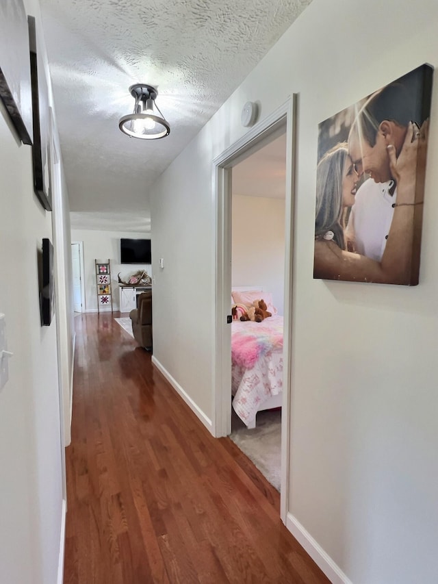 18189 2nd St, Eminence, MO 65466 - corridor featuring wood finished floors and a textured ceiling