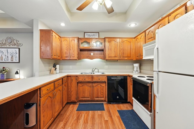 7815 Cozy Cove Rd Unit 3-15, Branson, MO 65616 - kitchen featuring white appliances, a tray ceiling, light wood-style floors, recessed lighting, and brown cabinets