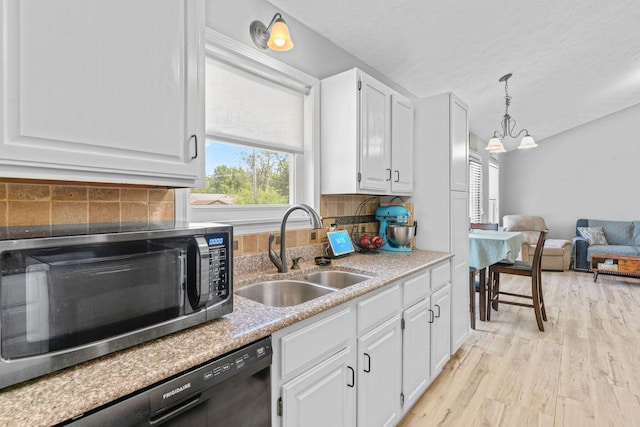 208 S Poplar Ct, Nixa, MO 65714 - kitchen with stainless steel microwave, dishwasher, white cabinets, light wood-type flooring, and pendant lighting