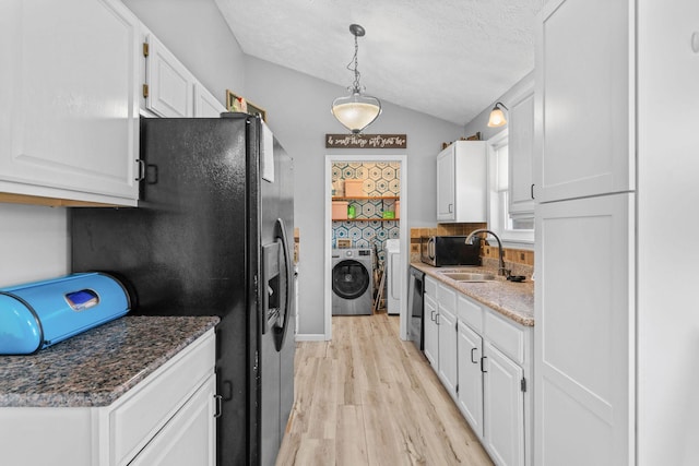 208 S Poplar Ct, Nixa, MO 65714 - kitchen featuring washing machine and dryer, white cabinetry, light wood finished floors, vaulted ceiling, and black appliances