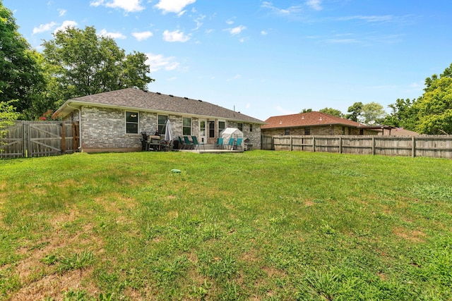 208 S Poplar Ct, Nixa, MO 65714 - rear view of house featuring a fenced backyard, a patio, and brick siding