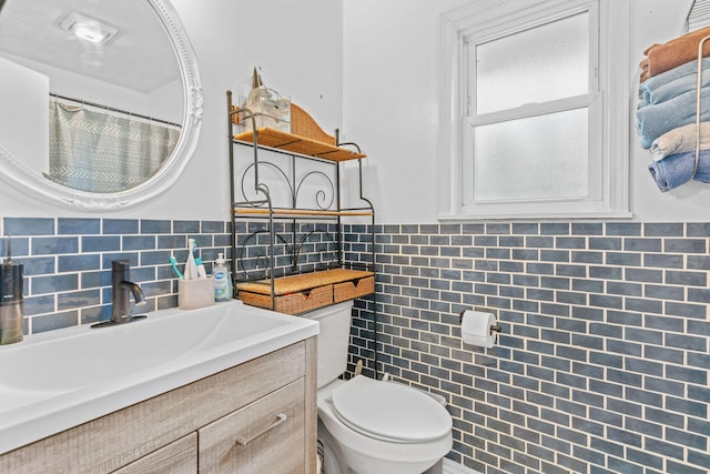 208 S Poplar Ct, Nixa, MO 65714 - bathroom featuring vanity, tile walls, and tasteful backsplash