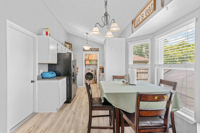 208 S Poplar Ct, Nixa, MO 65714 - dining space featuring separate washer and dryer, lofted ceiling, light wood-style floors, and a chandelier