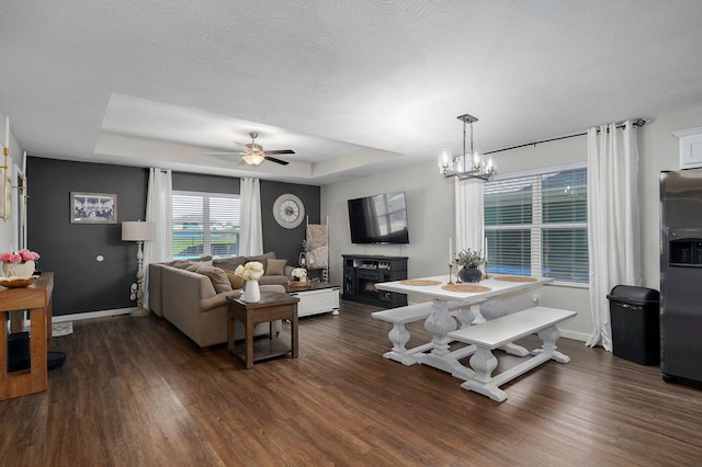 504 Gauge St, Willard, MO 65781 - living area with a raised ceiling, dark wood-type flooring, ceiling fan, and a chandelier
