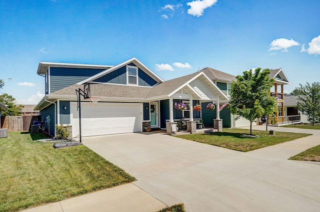 504 Gauge St, Willard, MO 65781 - craftsman-style home with driveway, an attached garage, stone siding, and roof with shingles