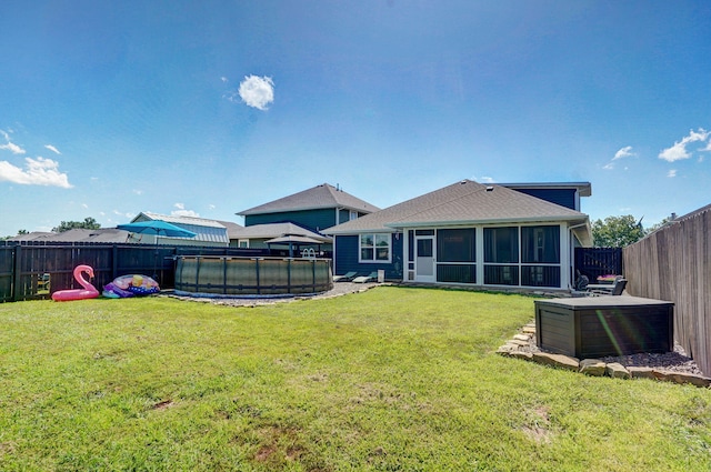504 Gauge St, Willard, MO 65781 - back of house featuring a sunroom, a fenced backyard, and a shingled roof