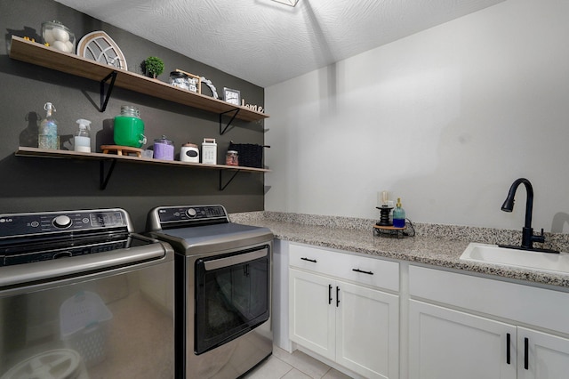 504 Gauge St, Willard, MO 65781 - laundry room featuring washer and dryer, cabinet space, and light tile patterned floors