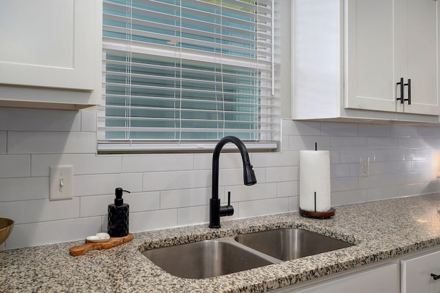 504 Gauge St, Willard, MO 65781 - kitchen view of white cabinetry, backsplash, and light stone counters