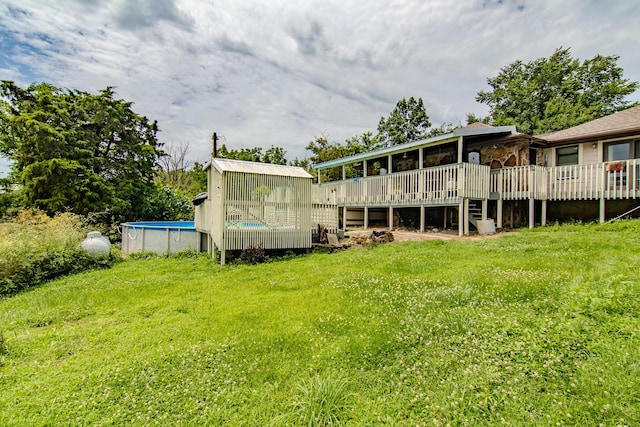 1746 Wall Rd, Mountain Grove, MO 65711 - rear view of house featuring a deck, an outdoor pool, and a lawn