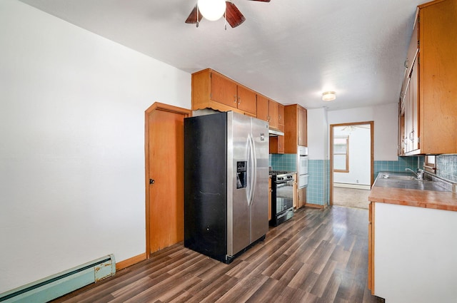 304 N Main St, Lockwood, MO 65682 - kitchen featuring stainless steel fridge, gas stove, a baseboard radiator, and tasteful backsplash