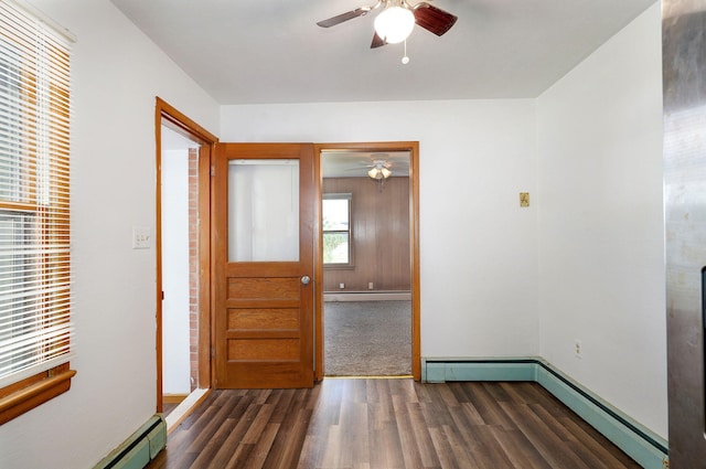 304 N Main St, Lockwood, MO 65682 - spare room with ceiling fan, a baseboard heating unit, wood finished floors, and a baseboard radiator