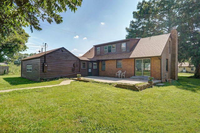 304 N Main St, Lockwood, MO 65682 - back of house featuring a chimney, a patio, a yard, and brick siding