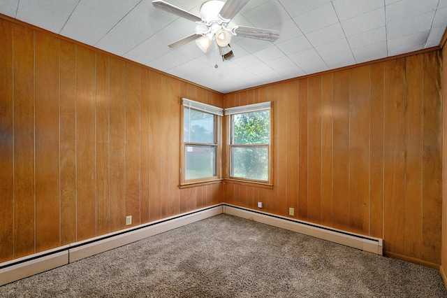 304 N Main St, Lockwood, MO 65682 - empty room featuring carpet flooring, a ceiling fan, wooden walls, and a baseboard radiator