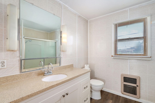304 N Main St, Lockwood, MO 65682 - bathroom with heating unit, wood finished floors, tile walls, vanity, and a shower stall