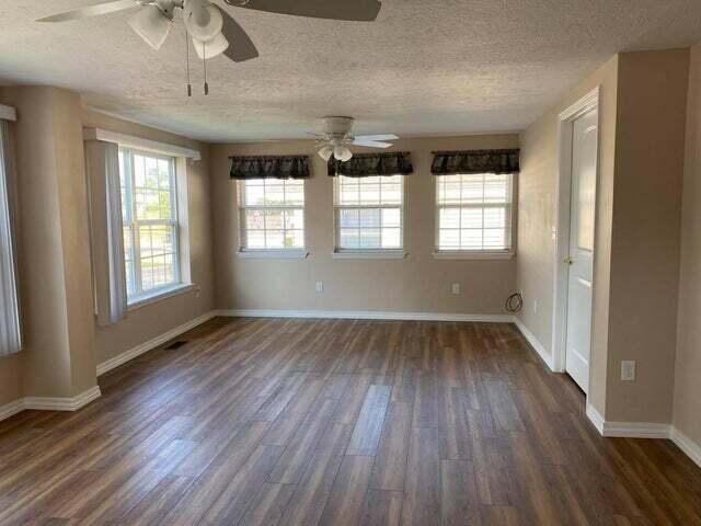 203 Forest Park Ln, Branson, MO 65616 - empty room featuring ceiling fan, dark wood finished floors, and a textured ceiling