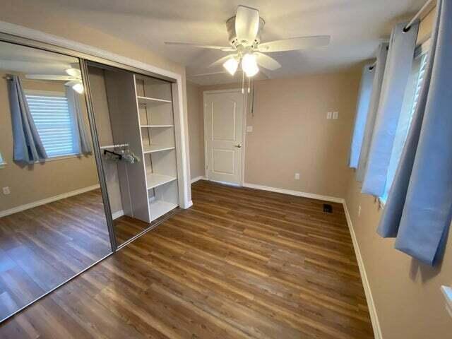 203 Forest Park Ln, Branson, MO 65616 - unfurnished bedroom featuring wood finished floors, a closet, and ceiling fan