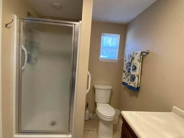 203 Forest Park Ln, Branson, MO 65616 - full bath with vanity, a stall shower, and tile patterned flooring