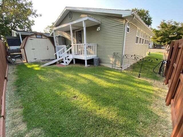 203 Forest Park Ln, Branson, MO 65616 - view of front facade with a storage shed and a fenced backyard