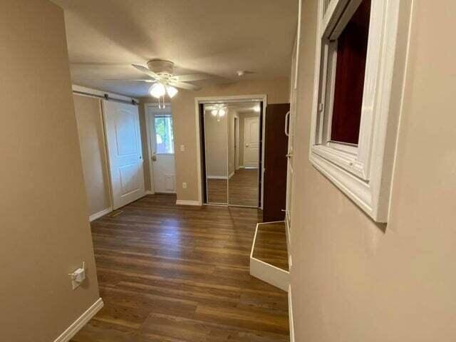 203 Forest Park Ln, Branson, MO 65616 - corridor with wood finished floors and a barn door