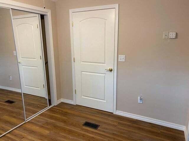 203 Forest Park Ln, Branson, MO 65616 - unfurnished bedroom featuring wood finished floors and a closet