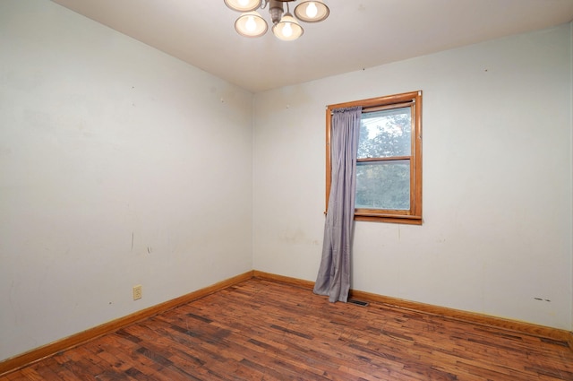225 S Main St, Greenfield, MO 65661 - unfurnished room with a chandelier and wood finished floors