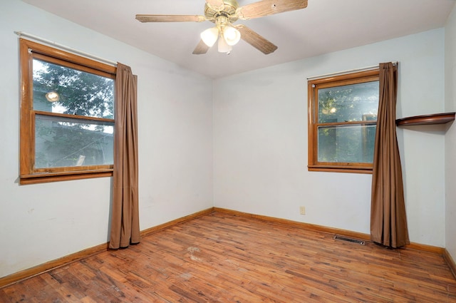 225 S Main St, Greenfield, MO 65661 - empty room with wood finished floors and a ceiling fan